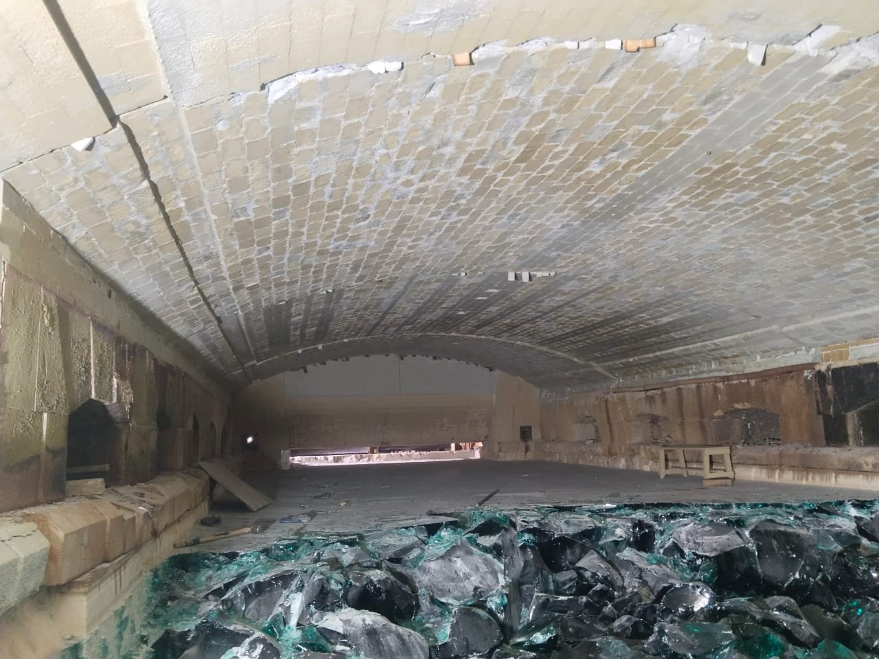 Inside the 600 ton melting furnace of the 150 tonne per day float glass plant, looking along the crown, with cullet on the furnace floor